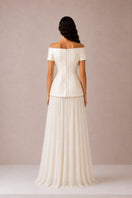 Nihan Peker Valentina maxi skirt in vanilla fabric, flowing design with a high waist and elegant length on a model.