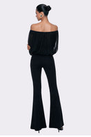 Black Valeria flared pants by Nana Jacqueline, shown in a stylish lookbook image with a fitted waistband and flowing leg design.