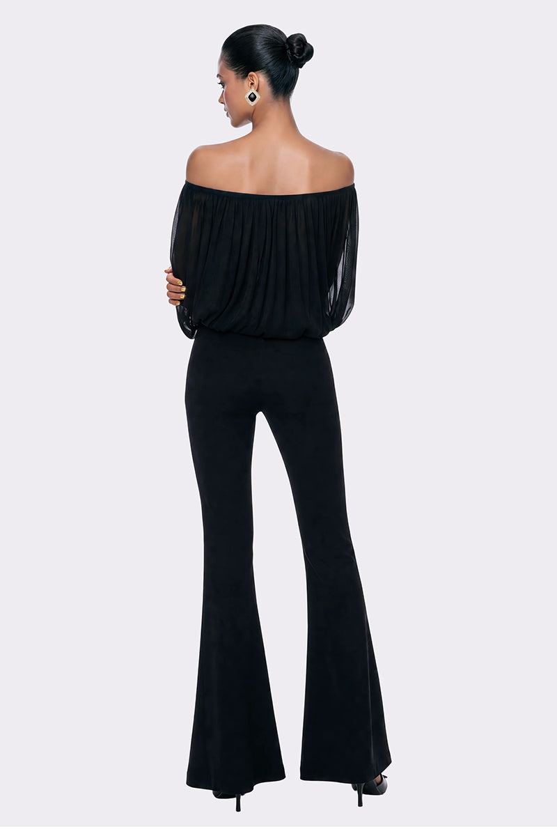 Black Valeria flared pants by Nana Jacqueline, shown in a stylish lookbook image with a fitted waistband and flowing leg design.