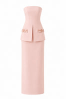 Light pink Vera dress by Nihan Peker, elegant gown with flowing fabric and subtle detailing, displayed on a hanger.
