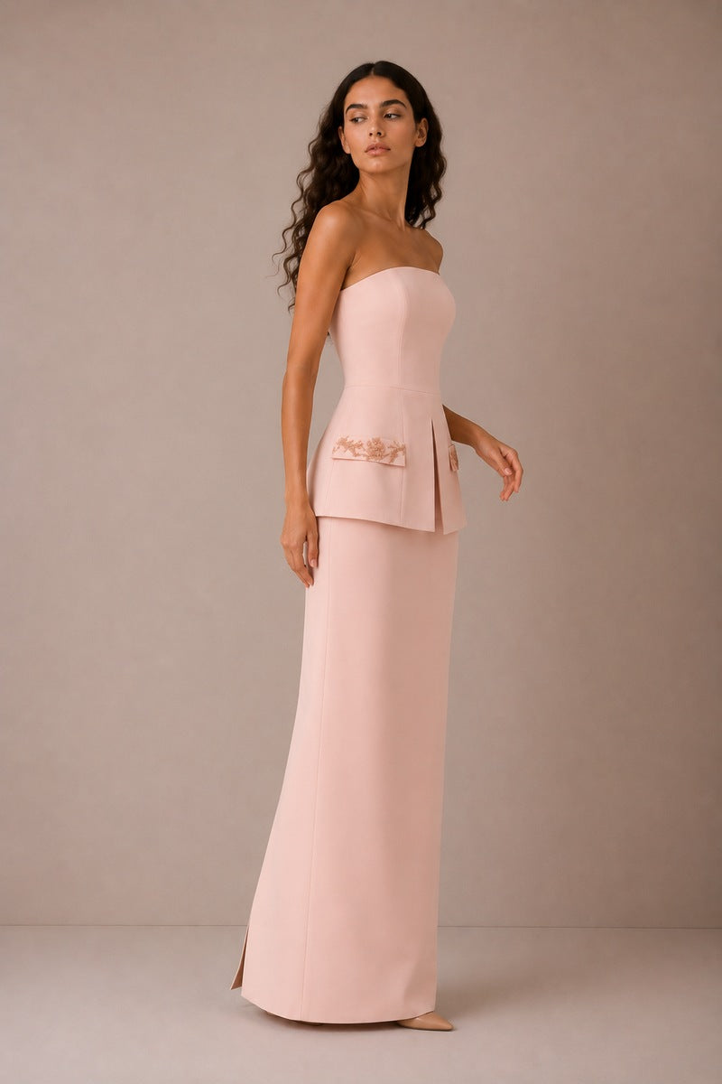 Light pink Vera gown by Nihan Peker, flowing fabric and elegant design, shown hanging on a wooden hanger.