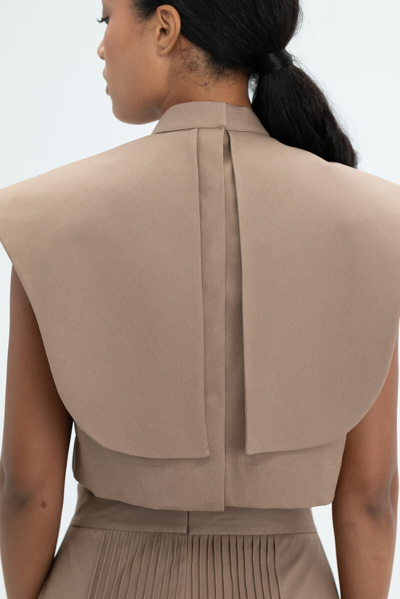 Ana + Maria Vestal cropped top in camel, showing a fitted sleeveless design with a round neckline and soft fabric texture.