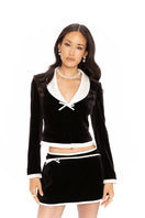 Black Victoria velvet blazer by Nana Jacqueline, shown on a model, featuring a tailored fit and elegant lapel details.