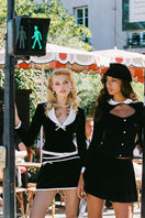 Black Victoria velvet mini skirt by Nana Jacqueline, shown with a fitted waist and soft velvet fabric.