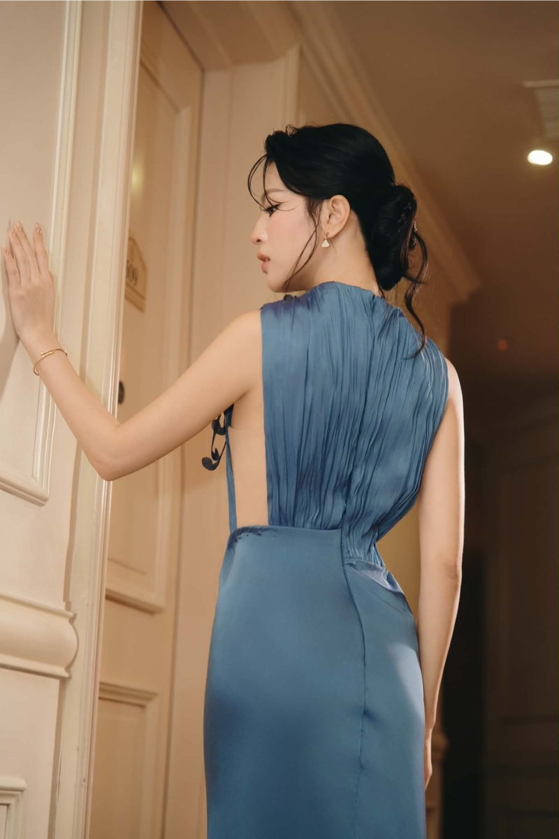 Lecia Vienna copper liquid pleat maxi gown in lumin blue, flowing fabric with elegant draping and a sophisticated silhouette.