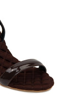 A pair of AERA Vivien brown patent-effect slingback sandals with open toes and strap details, shown from the front.