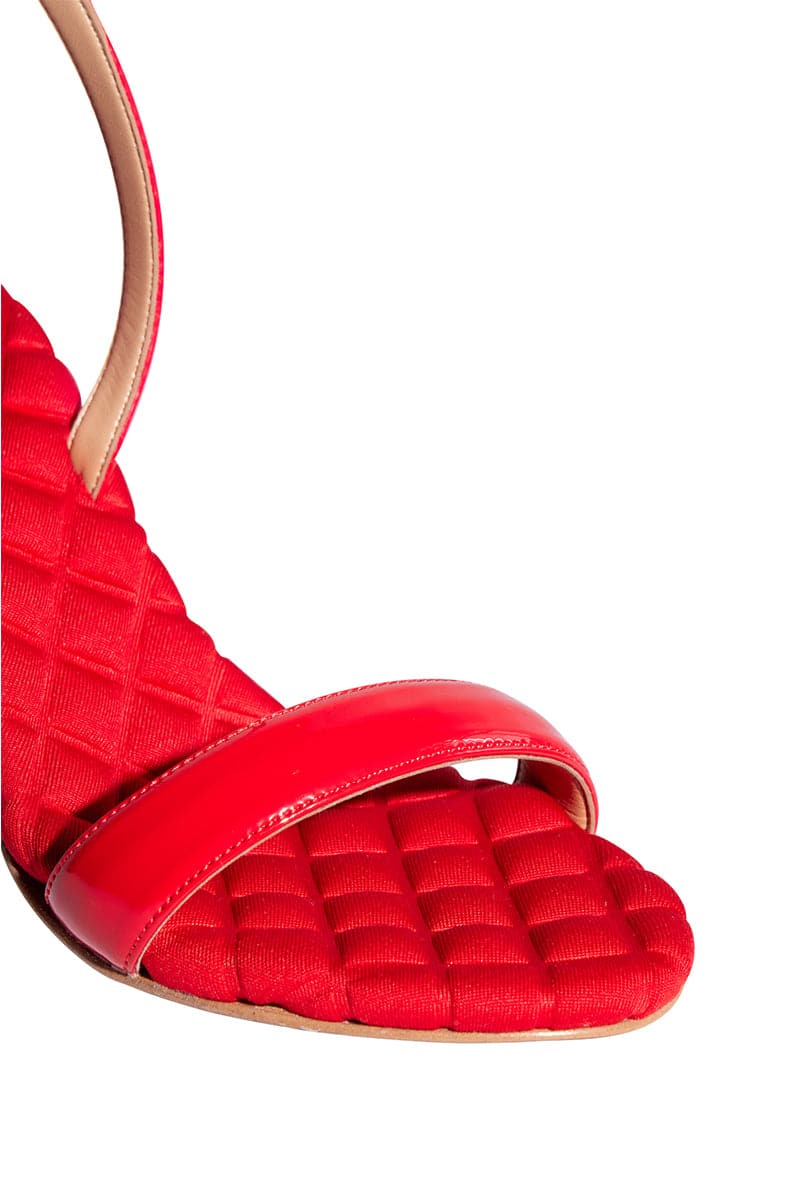 A pair of red patent-effect slingback sandals by AERA, featuring a sleek front view with open toes and stylish design.