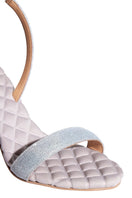 A pair of AERA Vivien silver lurex slingback sandals with open toe design, showcasing shimmering metallic finish and stylish heel.
