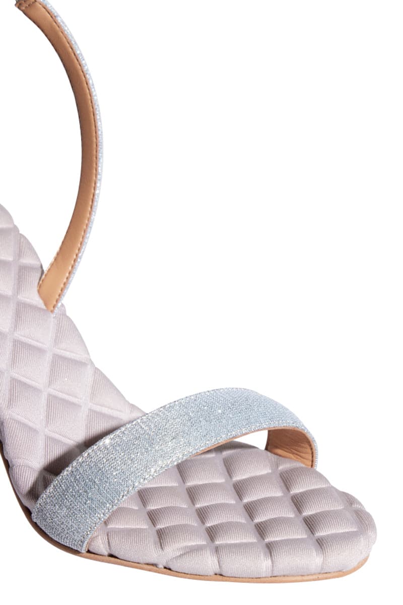 A pair of AERA Vivien silver lurex slingback sandals with open toe design, showcasing shimmering metallic finish and stylish heel.