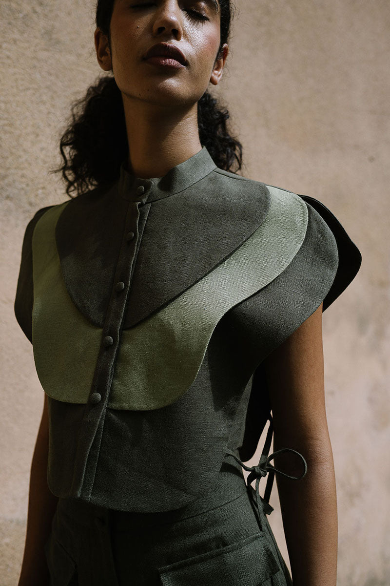 ANA + MARIA Vivra bib in lichen green and sage green, showcasing a stylish, soft tops design with a comfortable fit.