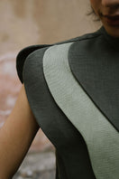 VIVRA bib in lichen green and sage green, worn as a stylish top, by ANA + MARIA, featuring soft fabric and a relaxed fit.