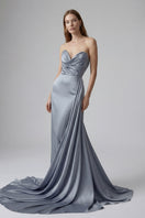 Elegant blue gown from Monetre, featuring a flowing design with intricate details, perfect for formal occasions.
