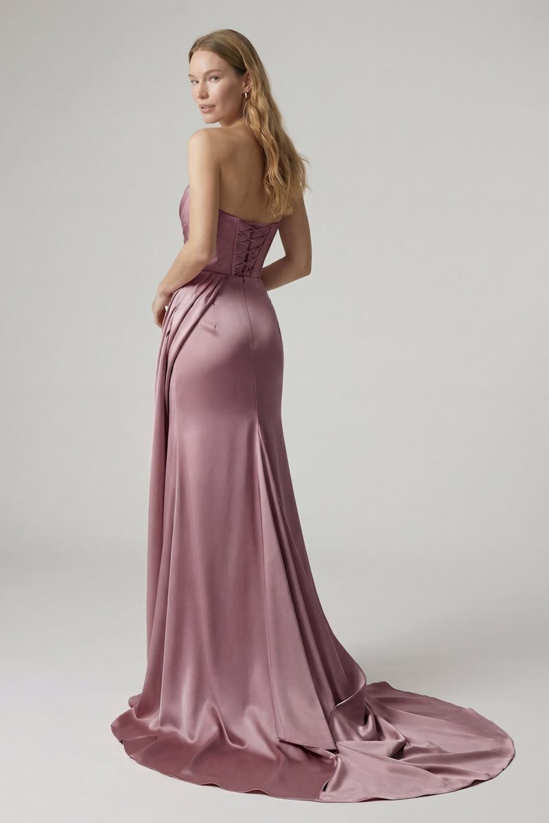Elegant rose-colored gown by Monetre, designed for formal occasions, with flowing fabric and intricate details.