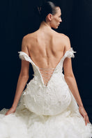 Elegant antique floral gown by Monetre featuring intricate lace and flowing fabric, displayed on a neutral background.