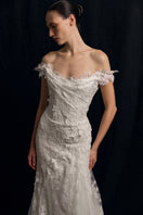 Elegant Fleur Antique gown by Monetre featuring intricate lace details and flowing fabric, perfect for formal occasions.