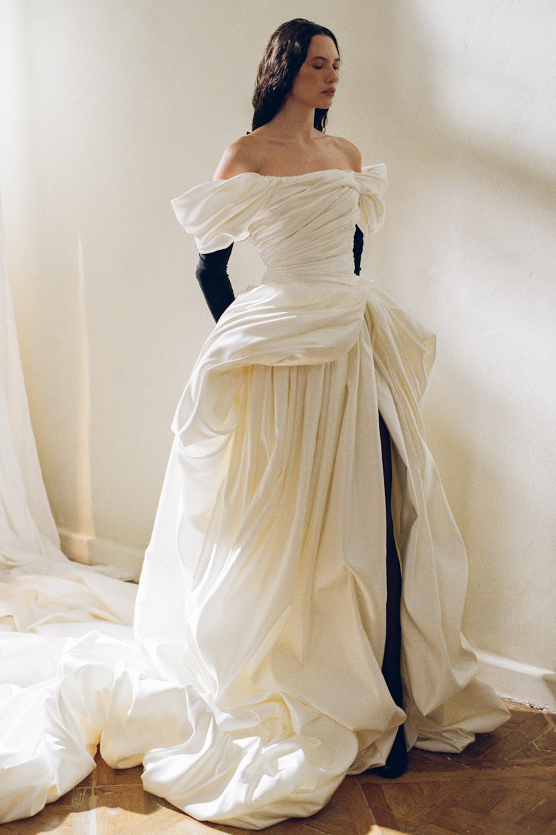 Elegant Monetre Venera Blanche gown with flowing fabric and intricate design, perfect for formal occasions.