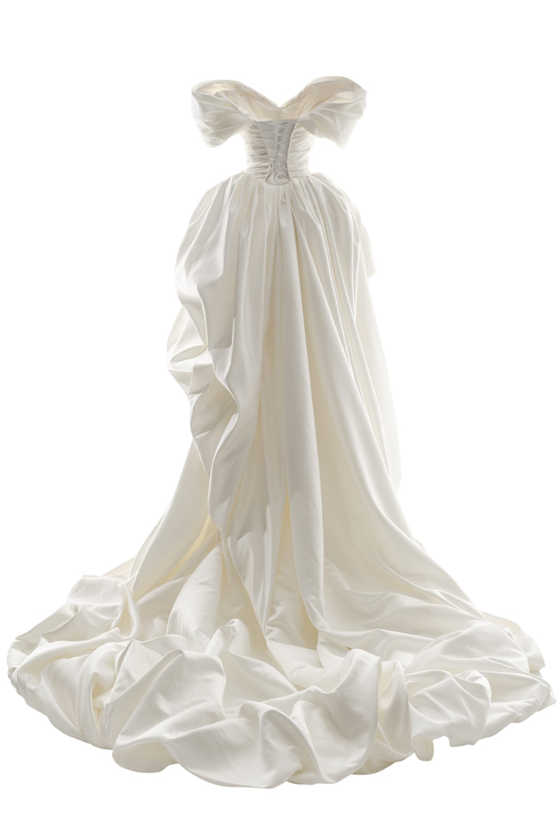 Elegant Venera Blanche gown by Monetre in off-white fabric, featuring flowing design and subtle detailing.