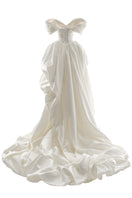 Elegant Venera Blanche gown by Monetre in off-white fabric, featuring flowing design and subtle detailing.