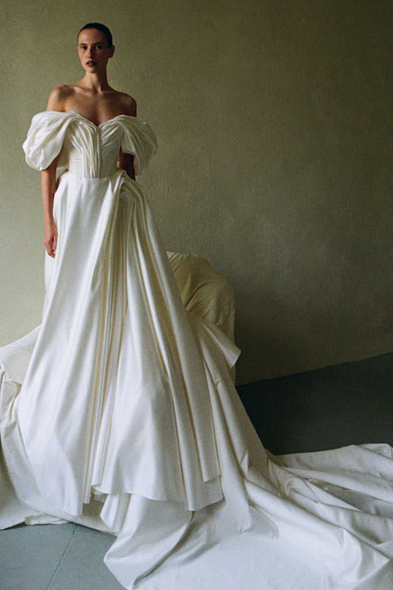 Elegant Monetre Grace Gown in soft fabric with flowing design, featuring intricate detailing and a graceful silhouette.