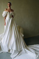 Elegant Monetre Grace Gown in soft fabric with flowing design, featuring intricate detailing and a graceful silhouette.