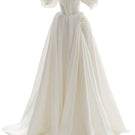 Off-white Grace gown by Monetre featuring elegant fabric and a flowing design, perfect for formal occasions.