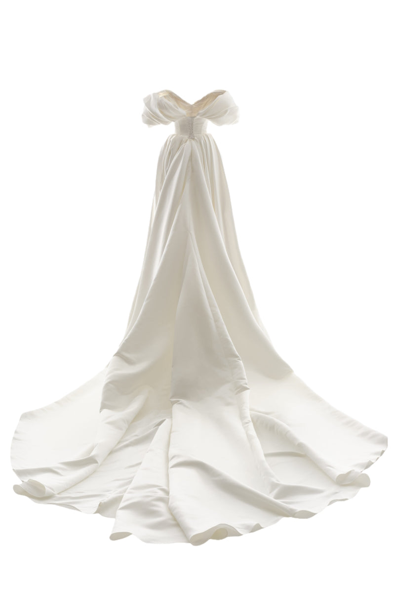 Off-white Grace gown by Monetre featuring elegant fabric and flowing design, perfect for formal occasions.