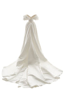 Off-white Grace gown by Monetre featuring elegant fabric and flowing design, perfect for formal occasions.