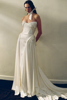 Elegant Luna Gown by Monetre featuring flowing fabric and intricate design, shown in a stylish dark shade.