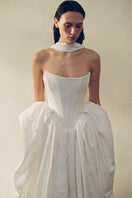 Elegant VESNA gown by Monetre featuring intricate lace details and flowing fabric, perfect for special occasions.
