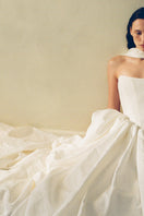 Elegant VESNA gown by Monetre featuring flowing fabric and intricate details, perfect for formal occasions.
