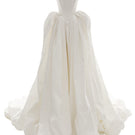 Off-white Vesna gown by Monetre featuring flowing fabric and elegant design, displayed on a mannequin.