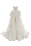 Off-white Vesna gown by Monetre featuring flowing fabric and elegant design, displayed on a mannequin.