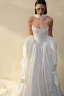 Elegant VESNA GOWN by Monetre featuring flowing fabric and intricate details, perfect for formal occasions.