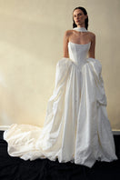Elegant VESNA gown by Monetre featuring flowing fabric and intricate details, perfect for formal occasions.