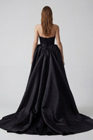 Black ETERNA gown by Monetre, elegant evening dress with flowing fabric and sophisticated design, suitable for formal occasions.