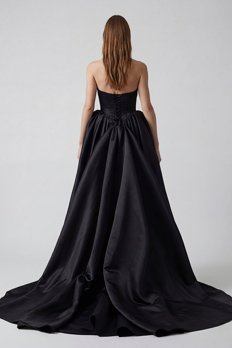 Black ETERNA gown by Monetre, elegant evening dress with flowing fabric and sophisticated design, suitable for formal occasions.