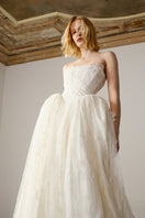 Elegant pale gown from Monetre's Agness collection, featuring flowing fabric and classic design for sophisticated style.