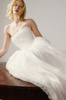 Elegant pale gown from Monetre's Agness collection, featuring flowing fabric and a graceful silhouette.