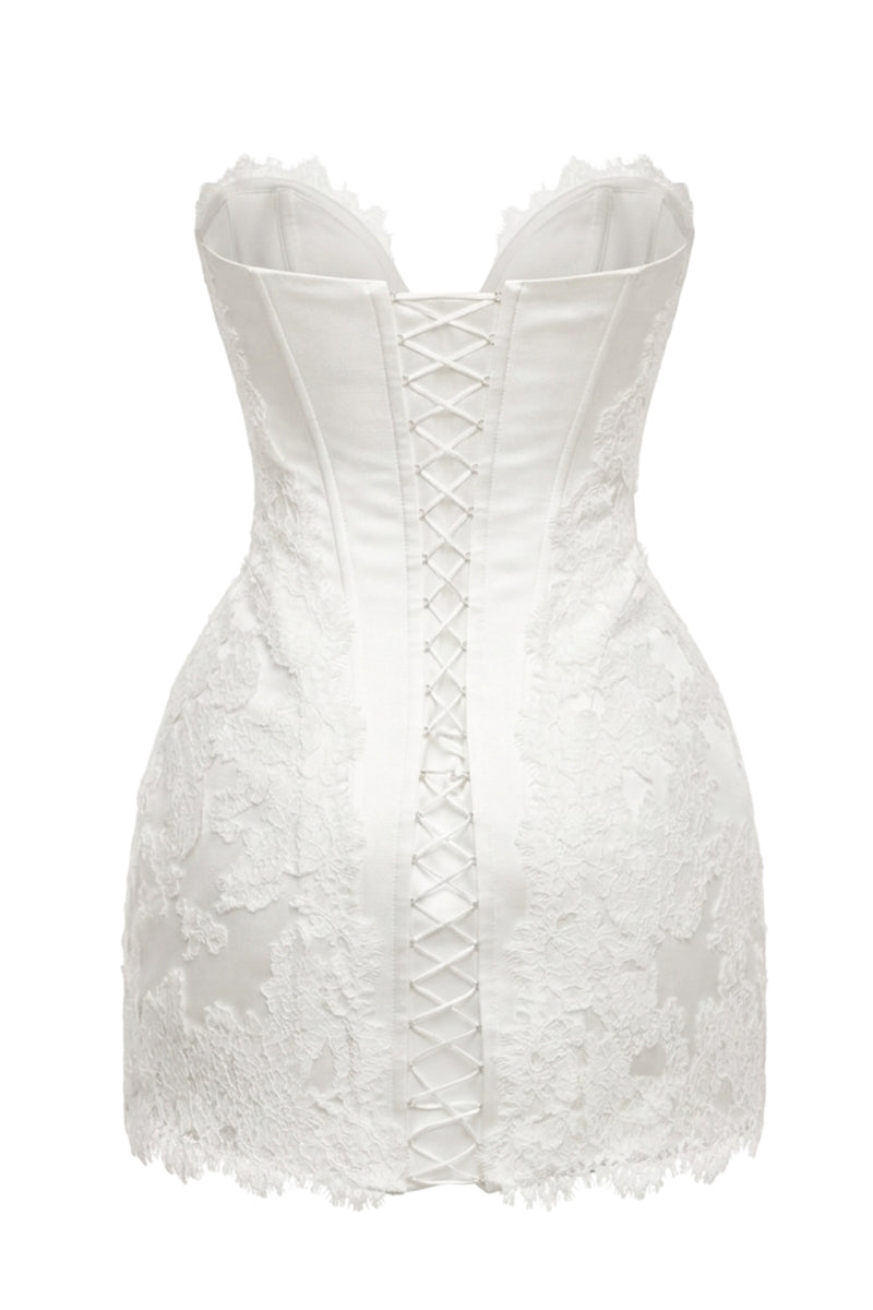 Off-white Serena Nuance gown by Monetre featuring elegant fabric and intricate design, displayed on a hanger.