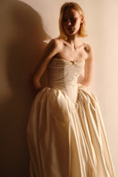 Elegant Monetre Elzabeth Diptych gown displayed on a mannequin with intricate detailing and flowing fabric.