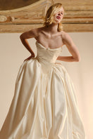 Elegant ELZABETH diptych gown by Monetre featuring flowing fabric and intricate detailing, displayed on a neutral background.