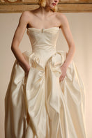 Elegant ELZABETH Diptych gown by Monetre featuring intricate detailing and flowing fabric, displayed on a mannequin.