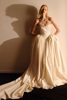 Elegant ELZABETH diptych gown by Monetre, featuring flowing fabric and intricate details, shown on a model.