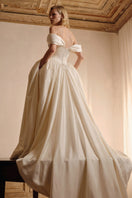 Elegant ivory Elizabeth Diptych gown by Monetre, featuring flowing fabric and intricate detailing, perfect for formal occasions.