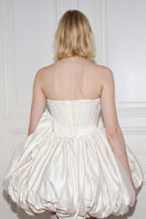 Off-white Lilith Petal gown by Monetre featuring delicate petal details and flowing fabric, elegant evening wear.