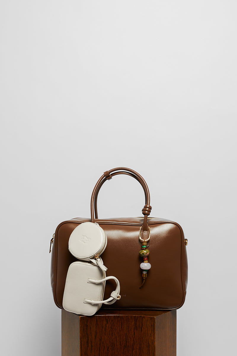 Leather work bag in mocha color with top handle, stylish and functional by Folklore The Label.