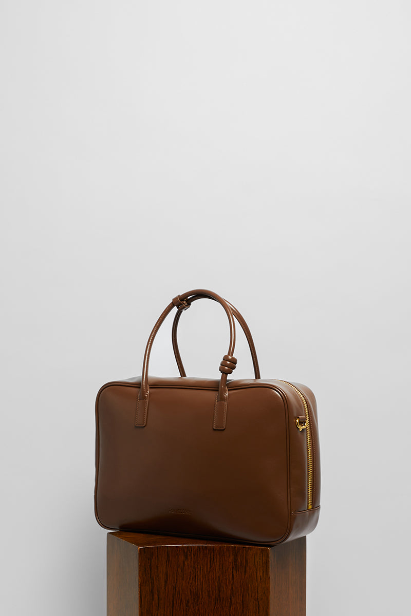 Leather work bag in mocha color from Folklore The Label, top handle design with sleek, structured appearance.