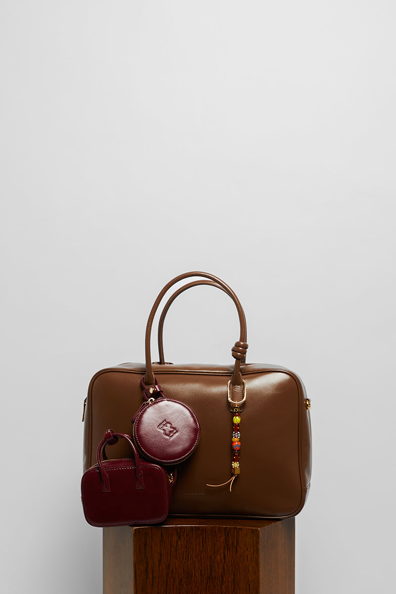 Leather work bag in mocha with top handle from FolkLore The Label, featuring a sleek design and sturdy construction.