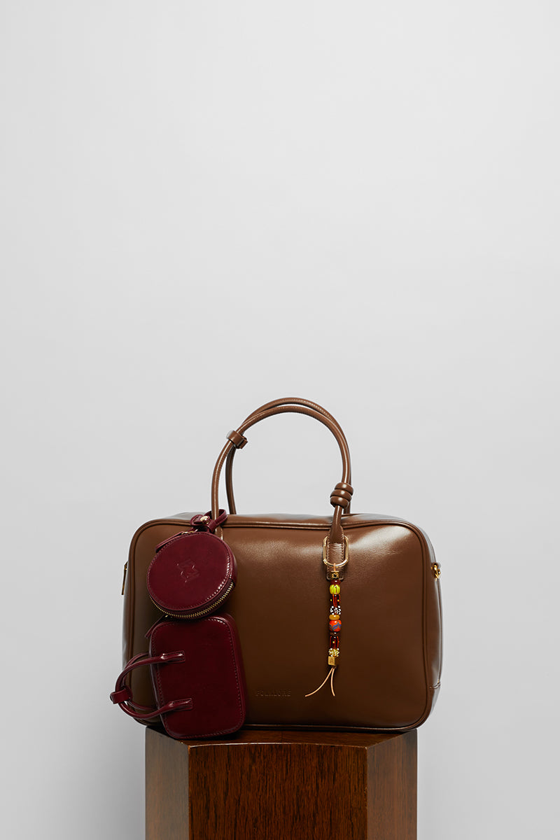 Leather top handle work bag in mocha color from Folklore The Label, featuring a sleek design and sturdy leather construction.