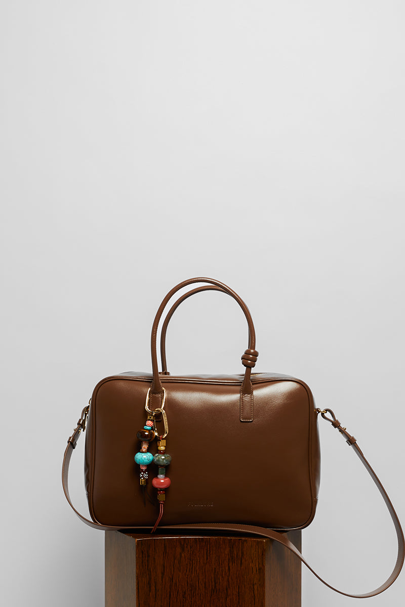 Leather work bag with top handle in mocha color from Folklore The Label, featuring a sleek, stylish design and durable leather material.